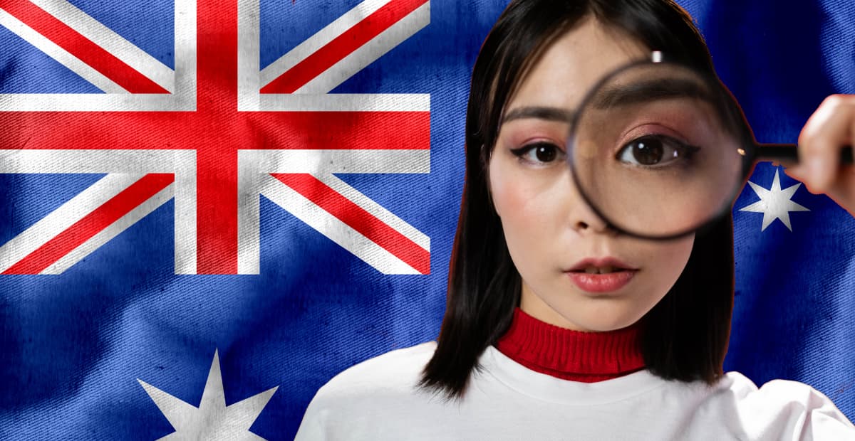 a woman looking through a magnifying glass with australian flag in the background