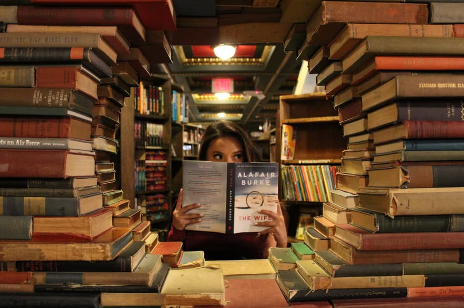 woman holding a book in the library